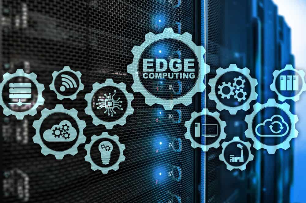 Interlocking cogwheels containing icons of various edge computing examples are displayed in front of racks of servers Interlocking cogwheels containing icons of various edge computing examples are displayed in front of racks of servers